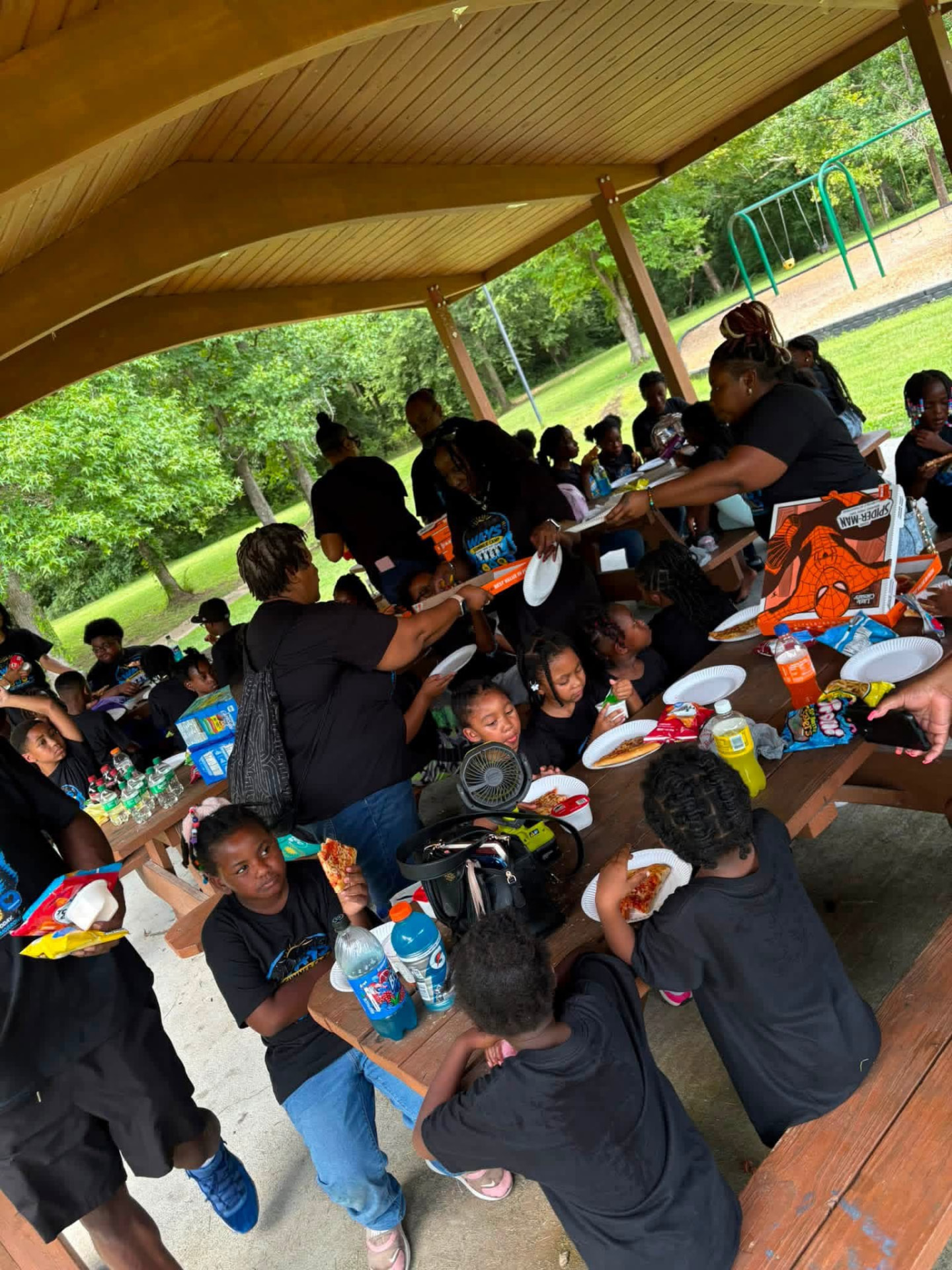 Families sharing a meal at the park pavilion
