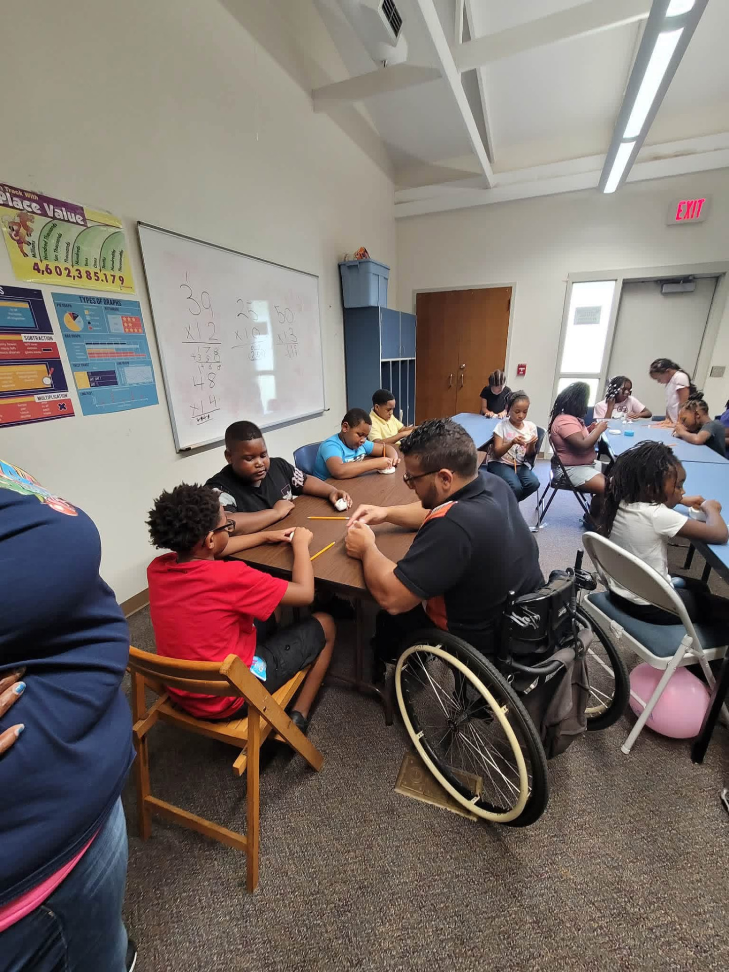 A mentor helping a student with schoolwork