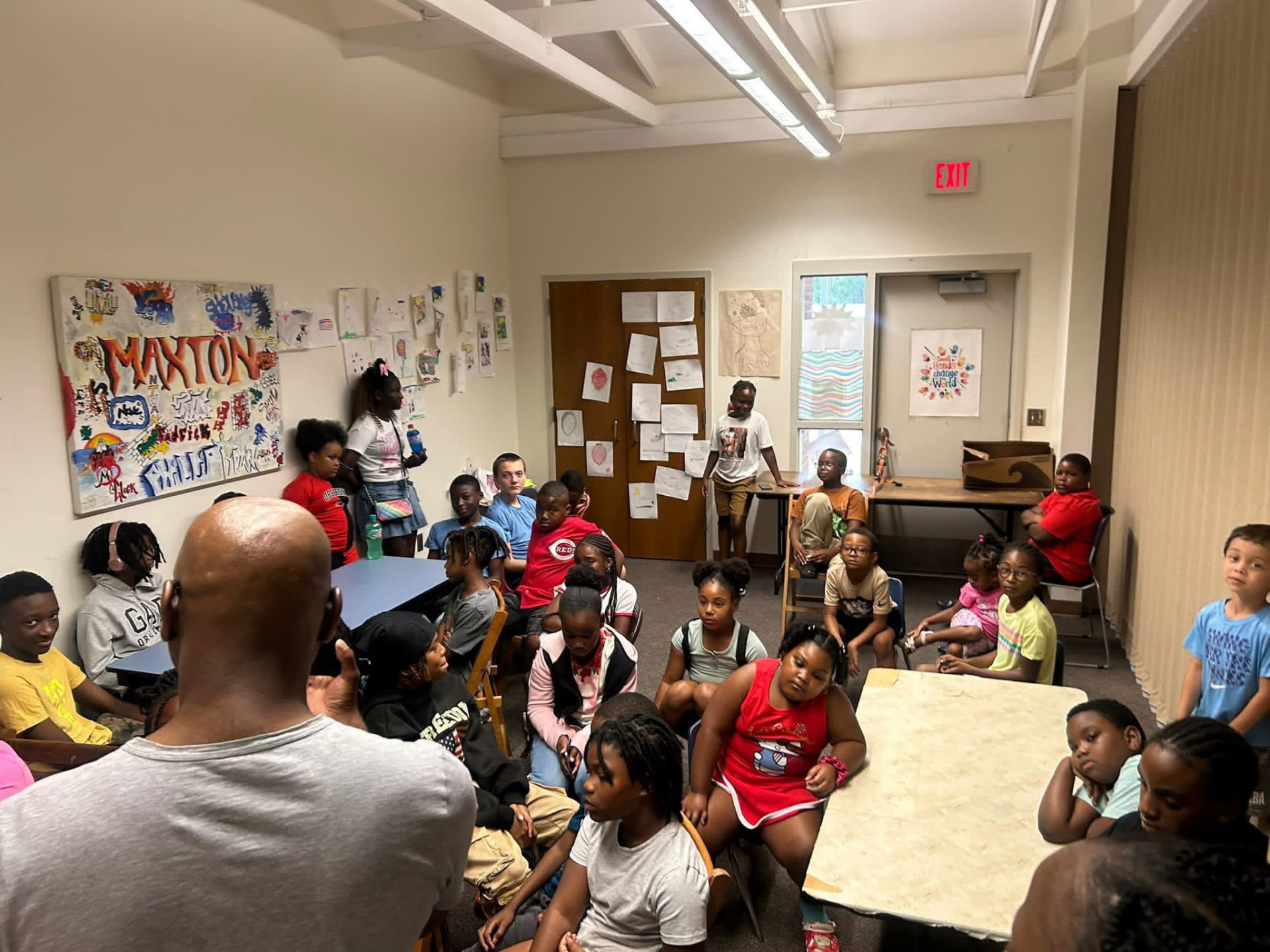 Group of kids gathered for a talk in the Maxton program room